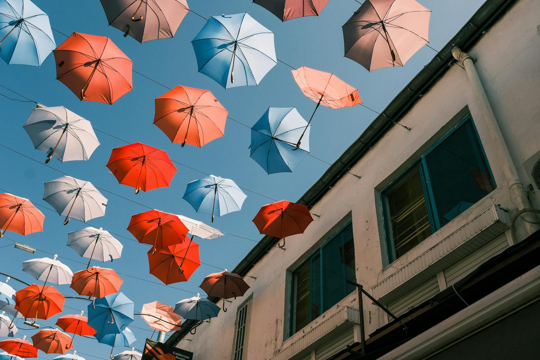 Rows of vibrant hand-painted paper umbrellas hanging above the main street of Bo Sang village during the festival