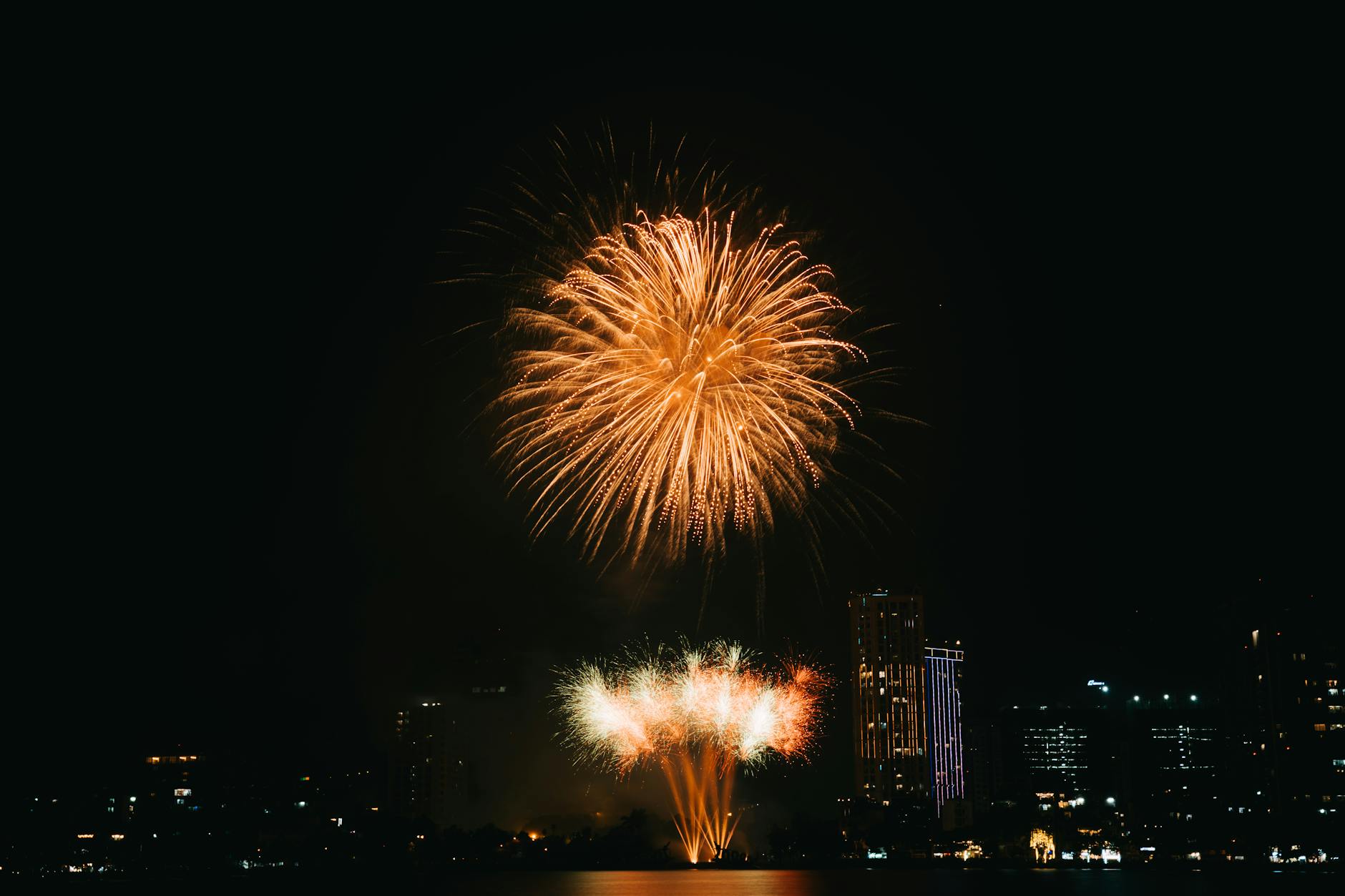 Fireworks exploding over the river during the Nakhon Sawan Chinese New Year celebration