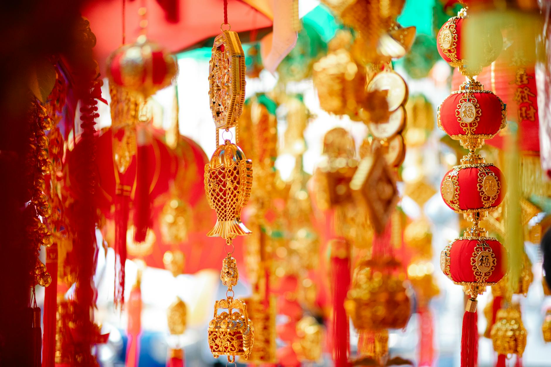 Red lanterns hanging above a packed street in Bangkok's Yaowarat Chinatown on Chinese New Year's Eve