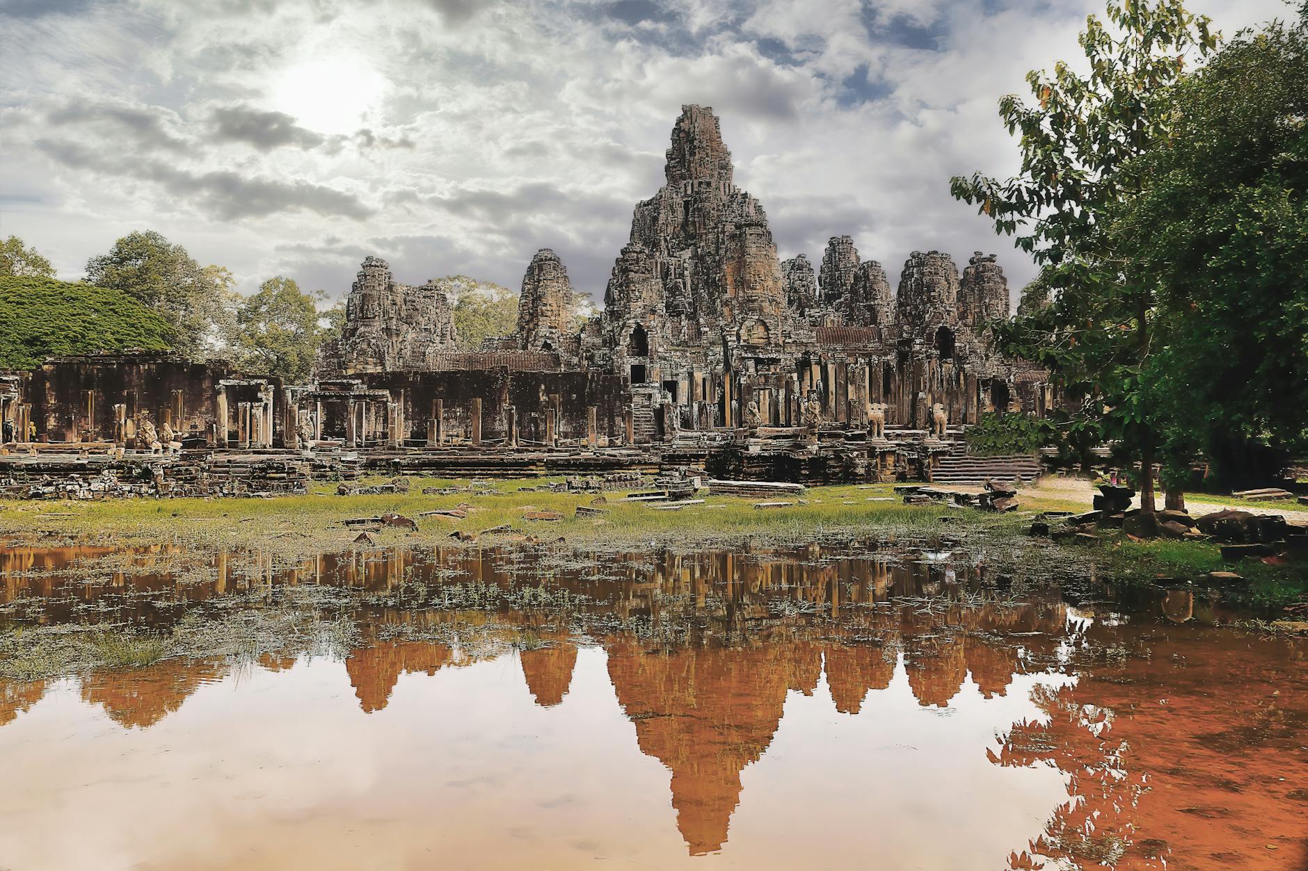 Ancient temple ruins at Sukhothai Historical Park illuminated by floating krathongs during the festival