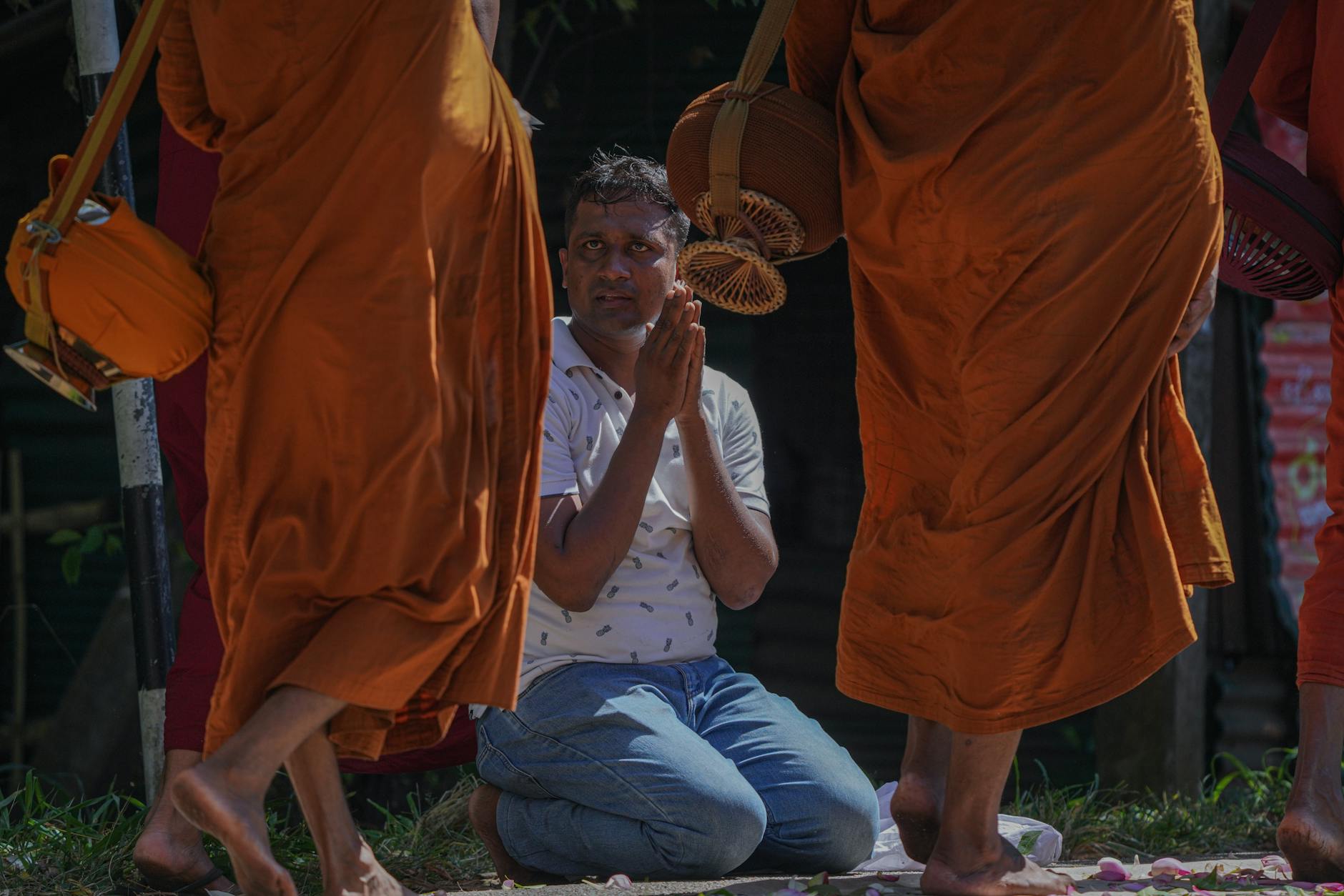Thai Buddhists offering food to monks during the morning alms round at a temple on Makha Bucha Day