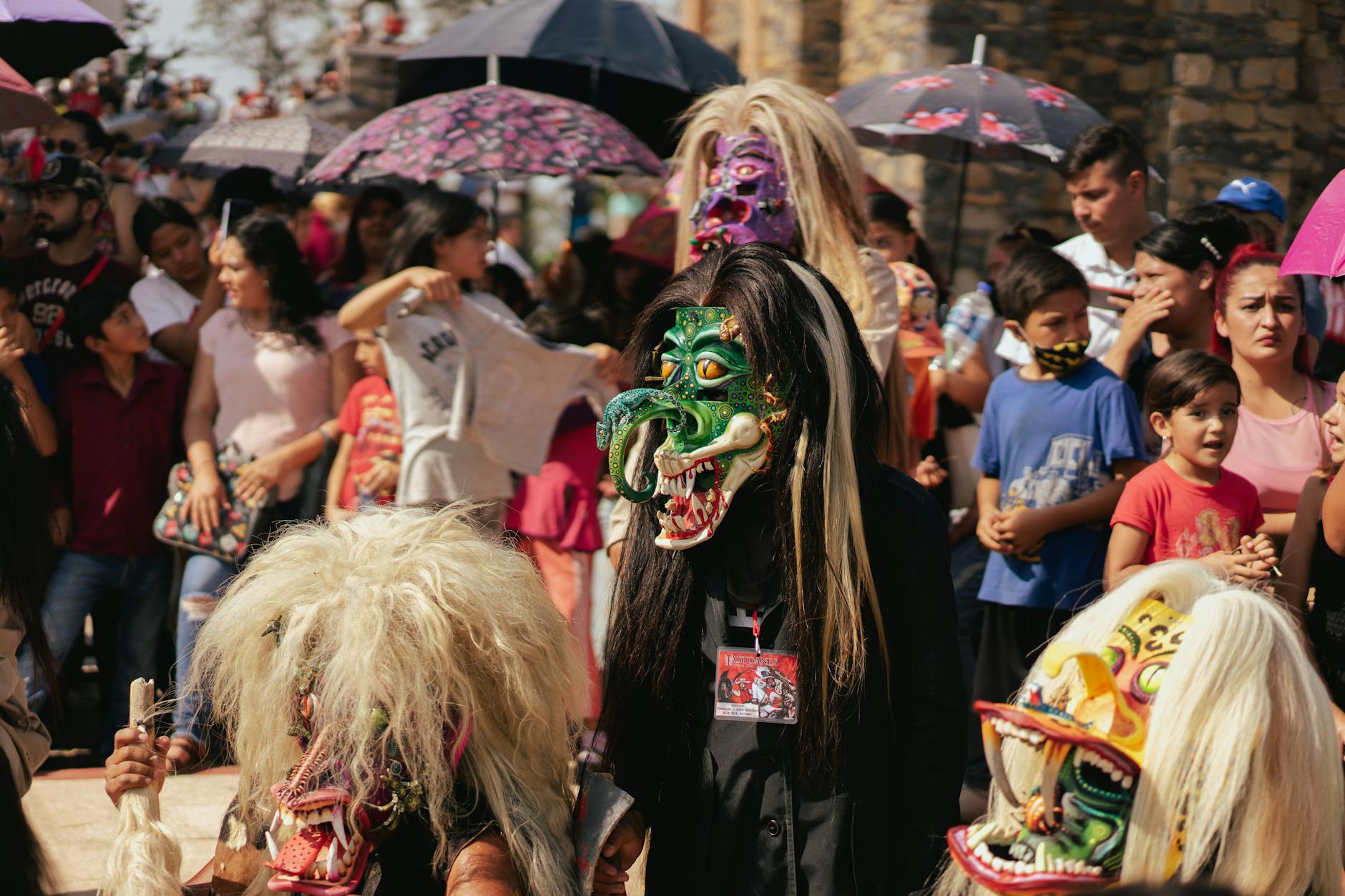 Locals wearing elaborate colorful ghost masks and costumes during Phi Ta Khon festival in Dan Sai, Loei