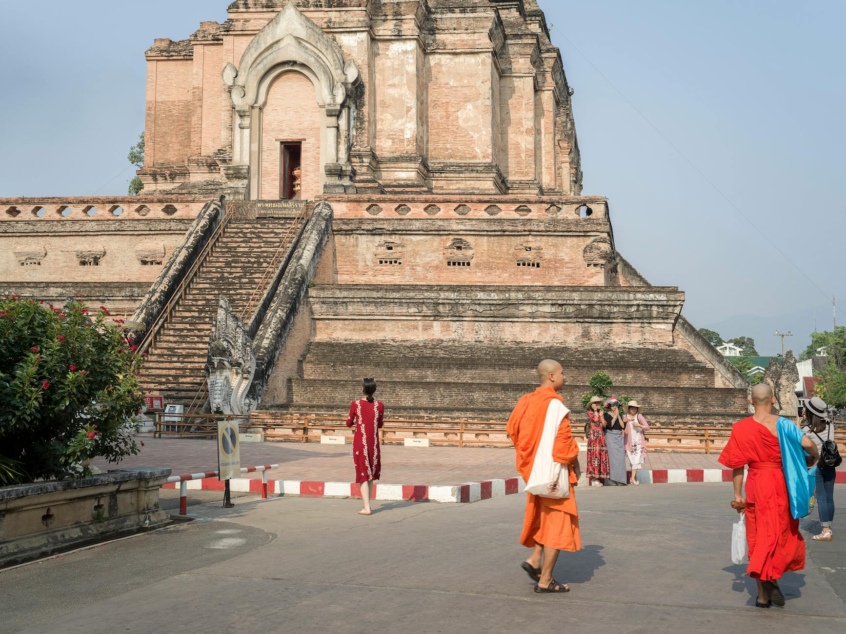 A tourist respectfully greeting a Buddhist monk with a wai gesture during Songkran