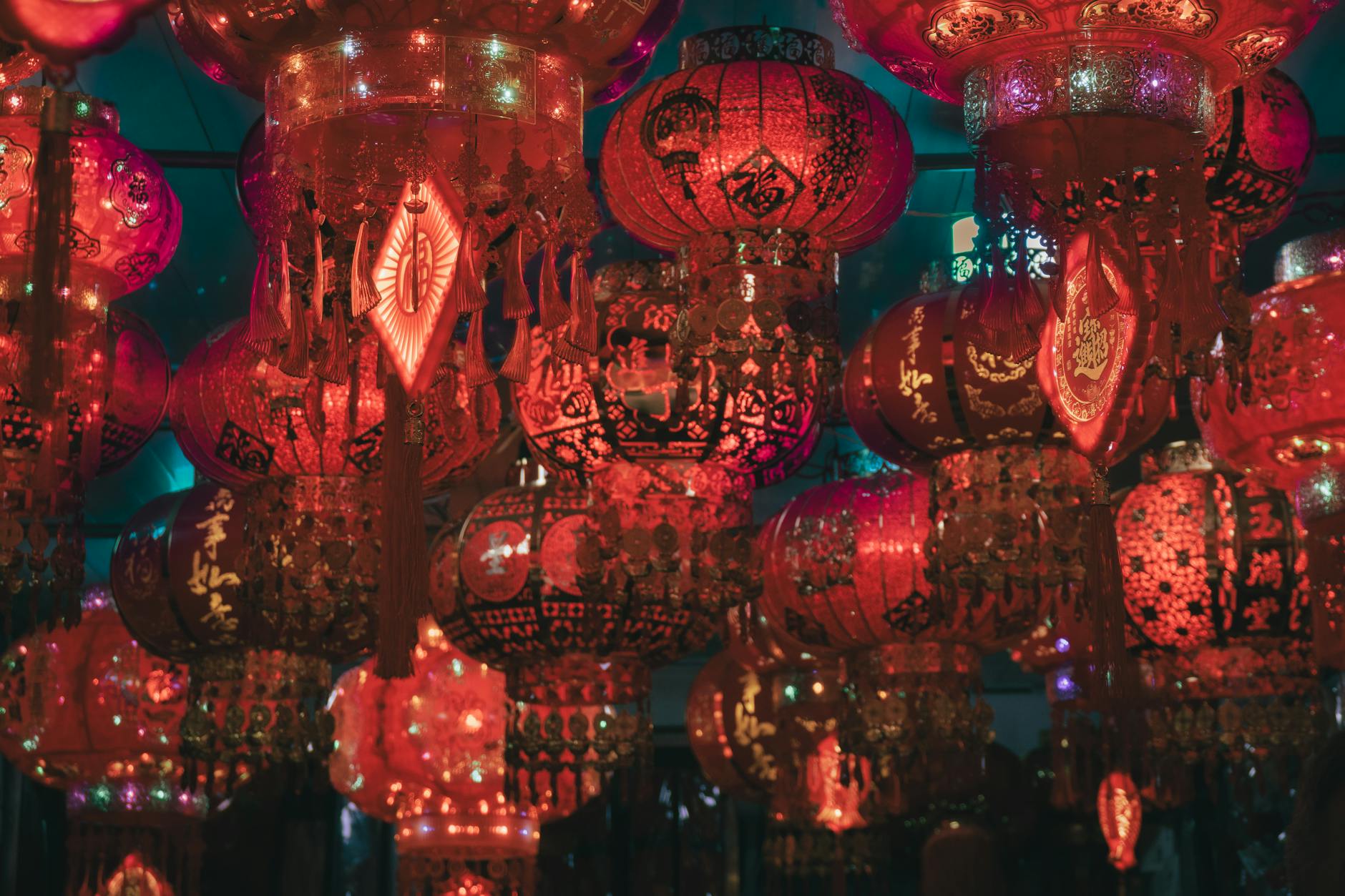 Red Chinese lanterns and a vibrant dragon dance procession in Bangkok's Chinatown during Lunar New Year celebrations