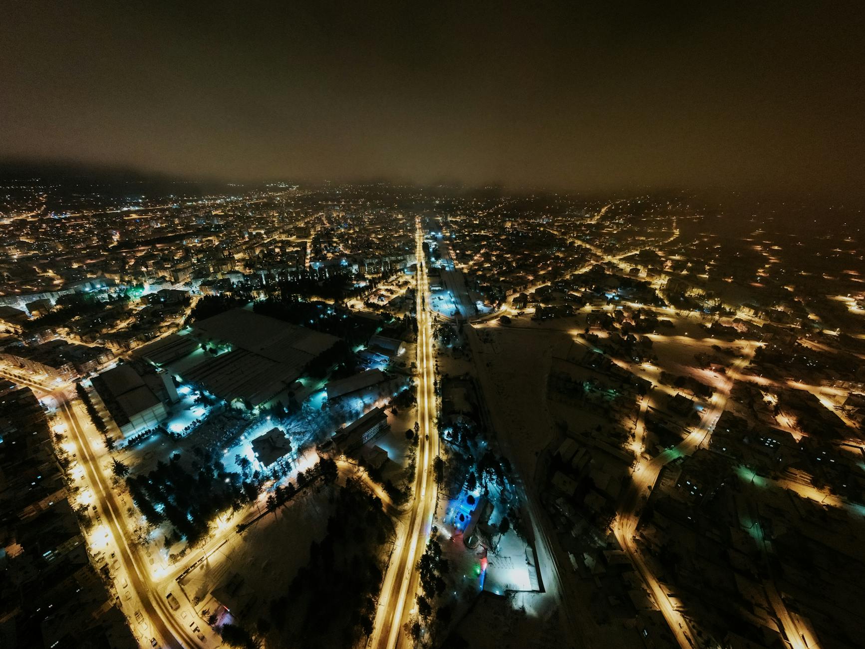 Aerial view of thousands of paper lanterns floating into the night sky over Chiang Mai during Yi Peng festival
