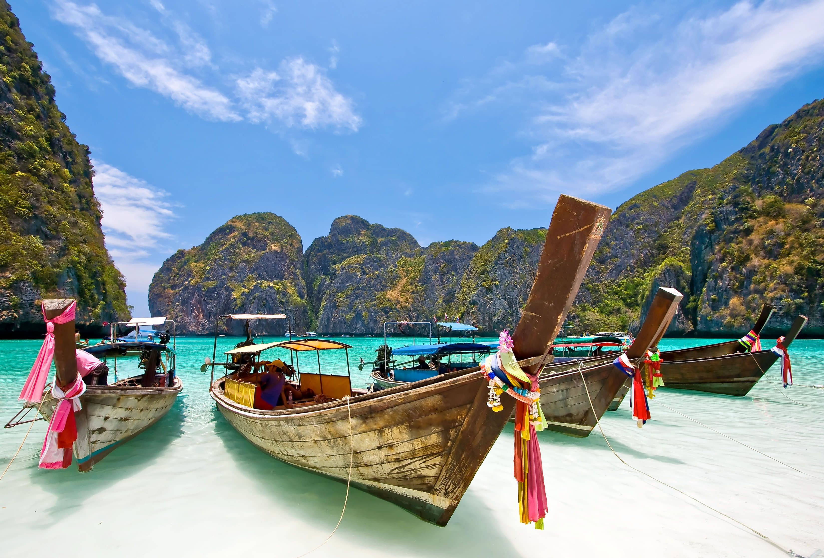 Long-tail boats moored at Maya Bay, Koh Phi Phi — where AIS coverage beats the competition