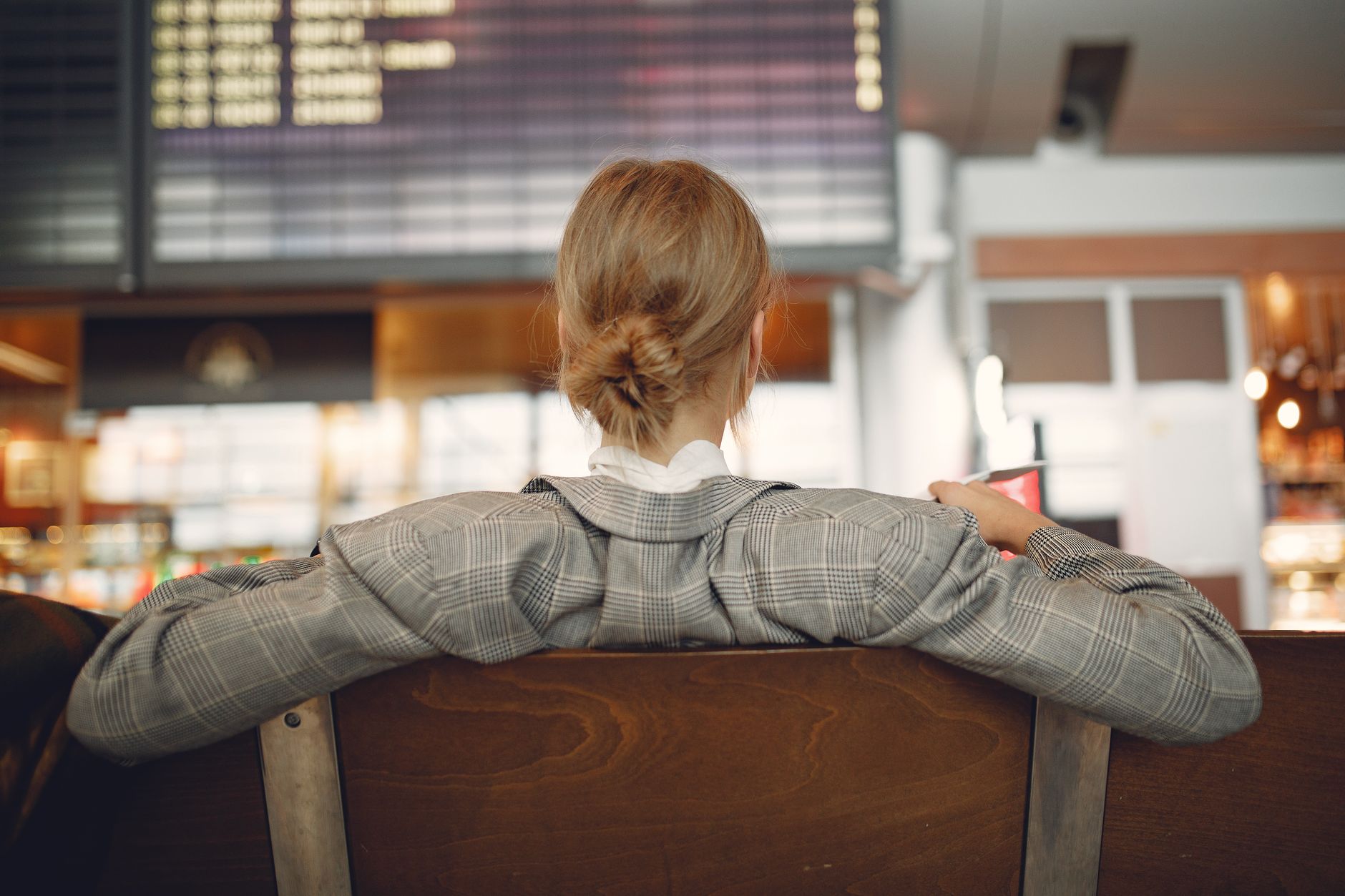 A traveler checking departure boards while waiting for a flight