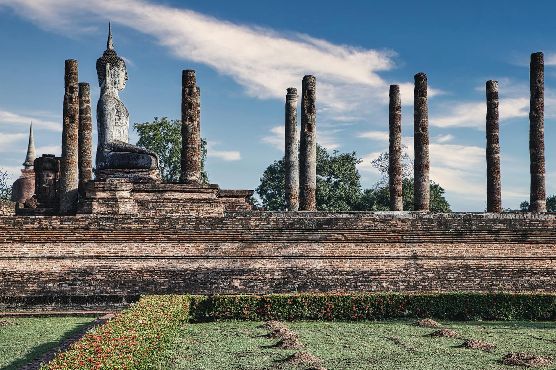 Standing Buddha statue at Phutthamonthon park illuminated during Visakha Bucha evening ceremony