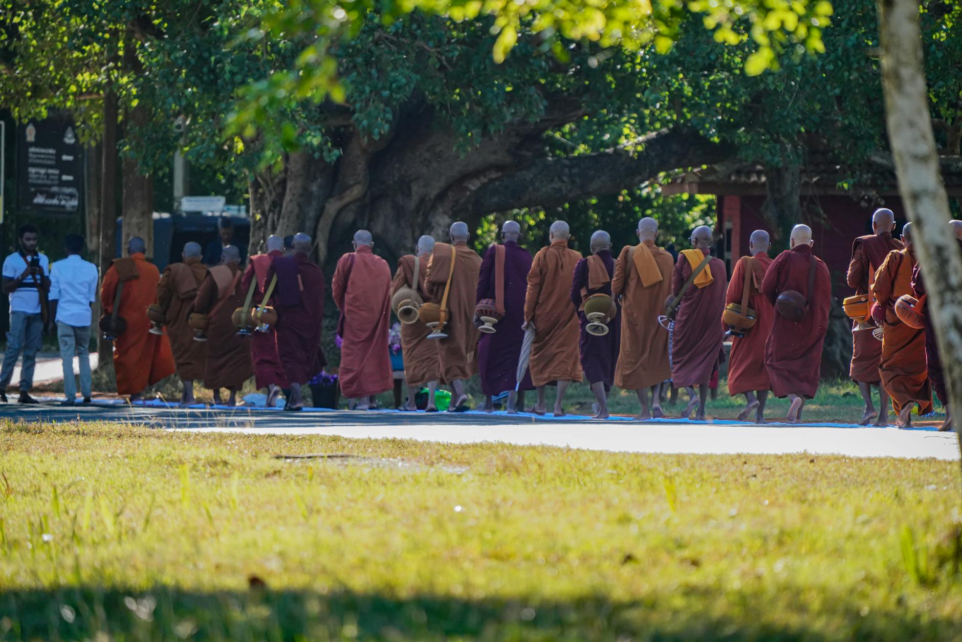 Thai Buddhists walk clockwise around temple hall holding candles during wian thian ceremony on Visakha Bucha Day