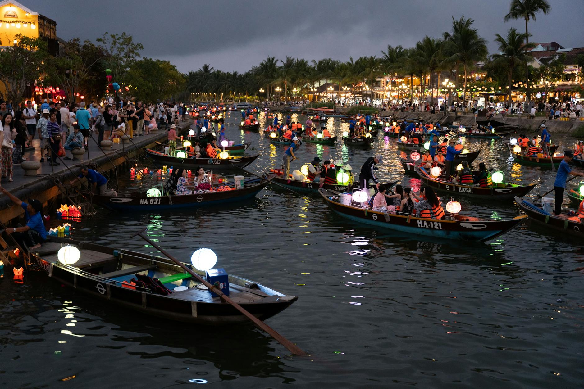 Lanterns reflecting in the Ping River near Nawarat Bridge during Yi Peng festival